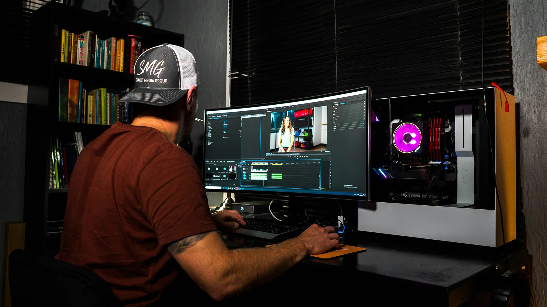 Professional video editor at a clean desk setup