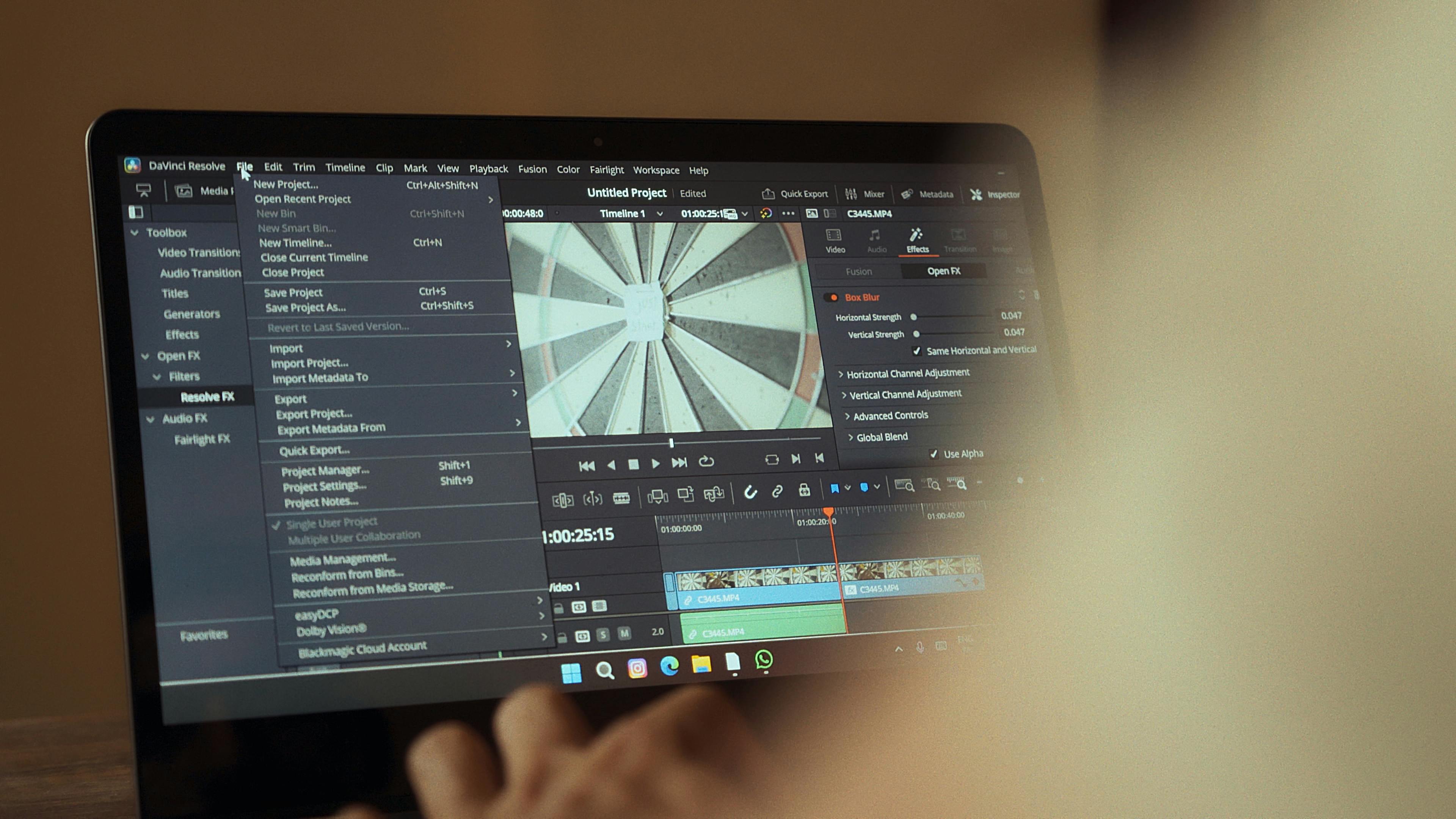 DaVinci Resolve color grading wheels and audio waveforms on MacBook