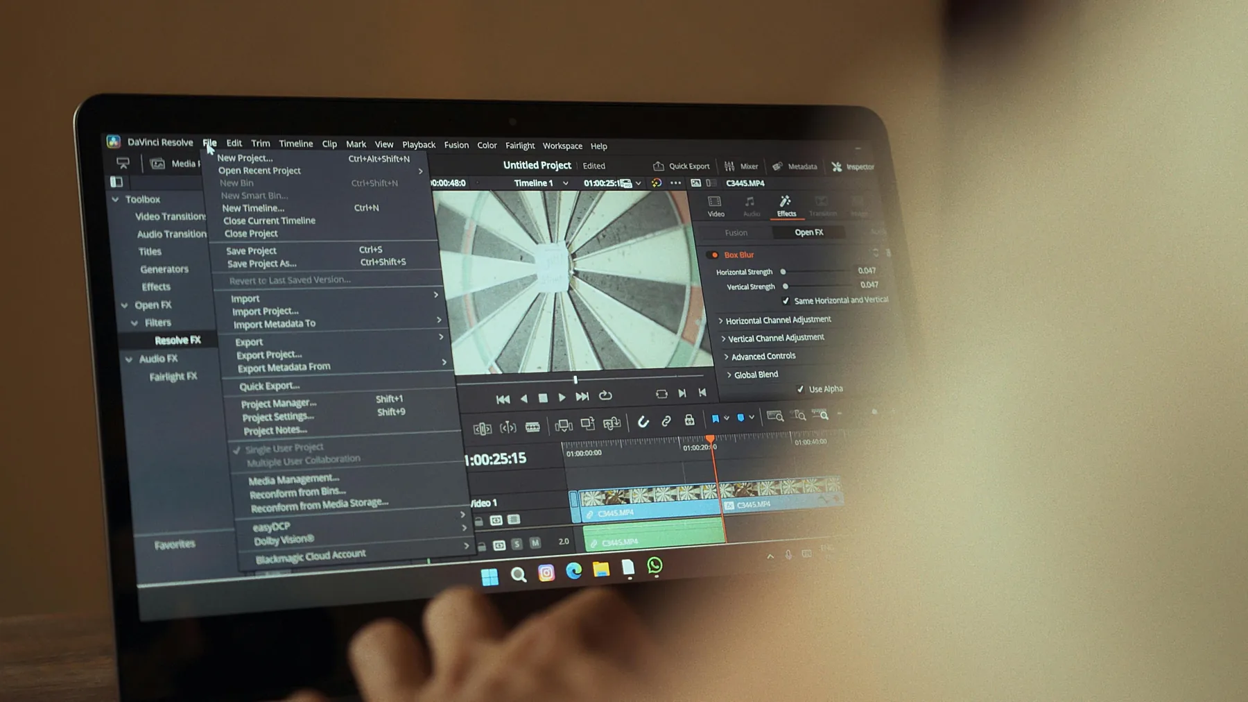 DaVinci Resolve color grading wheels and audio waveforms on MacBook