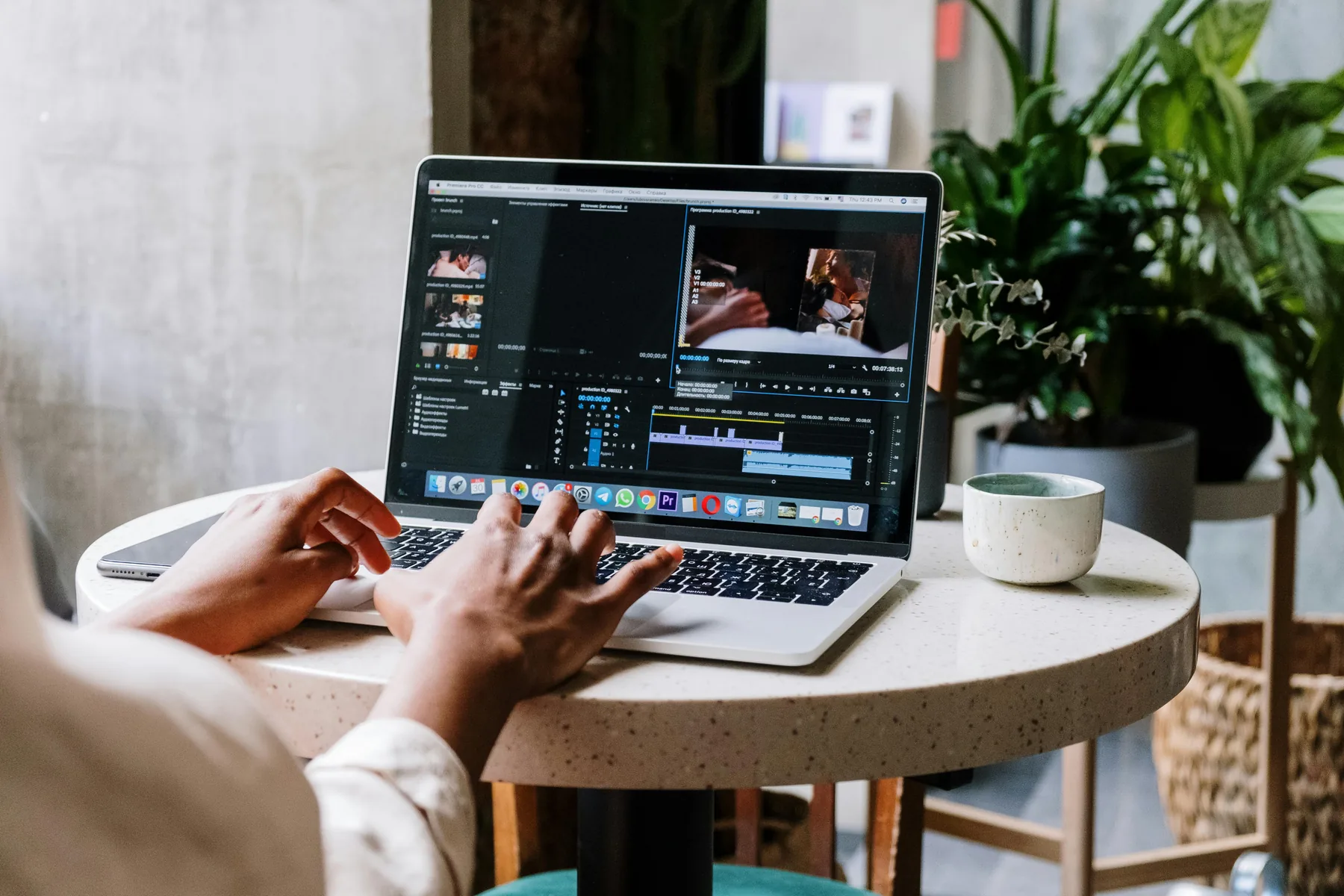 Adobe Premiere Pro project open on a MacBook Air showing timeline and color wheels