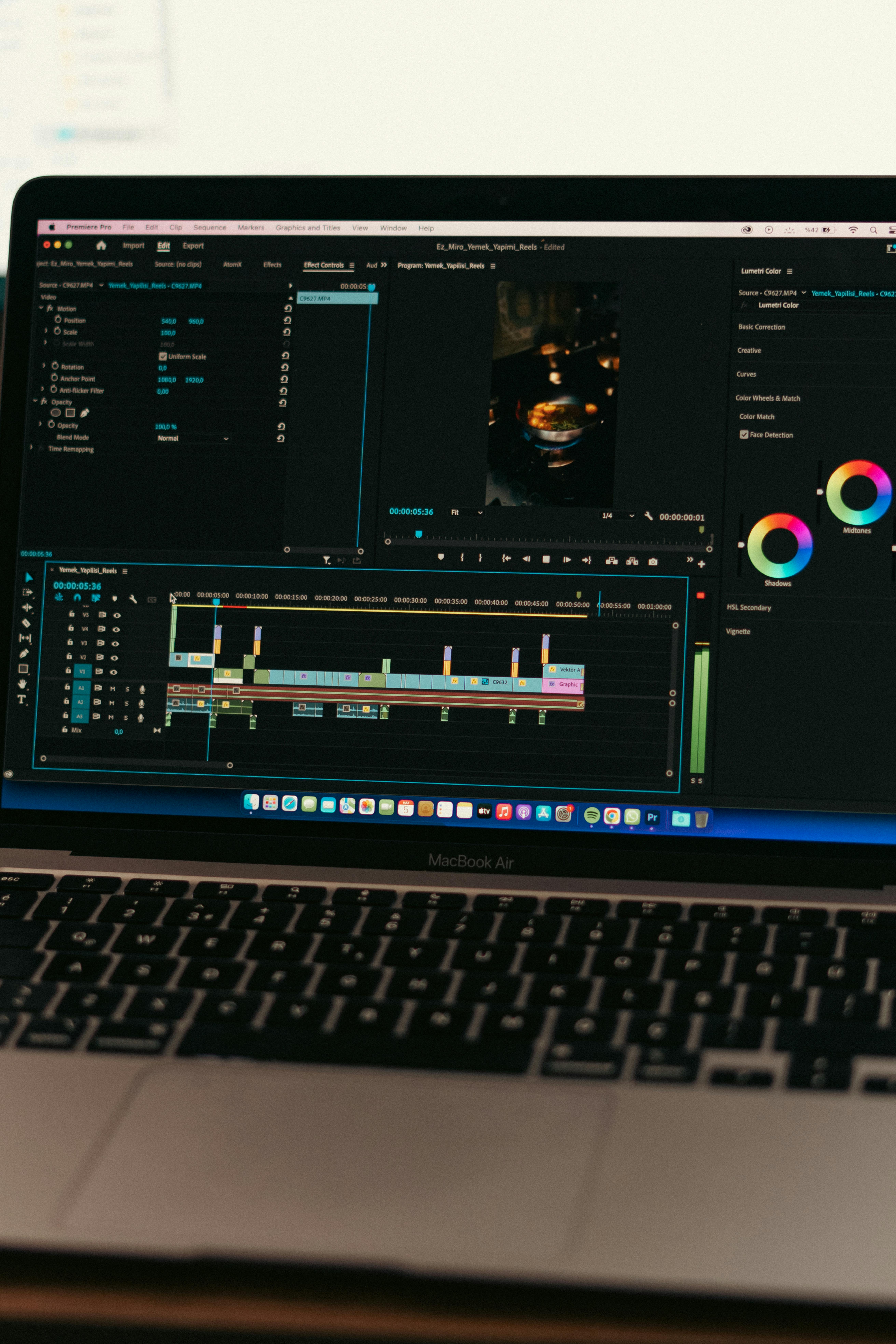 Video editor working in Adobe Premiere Pro on a MacBook
