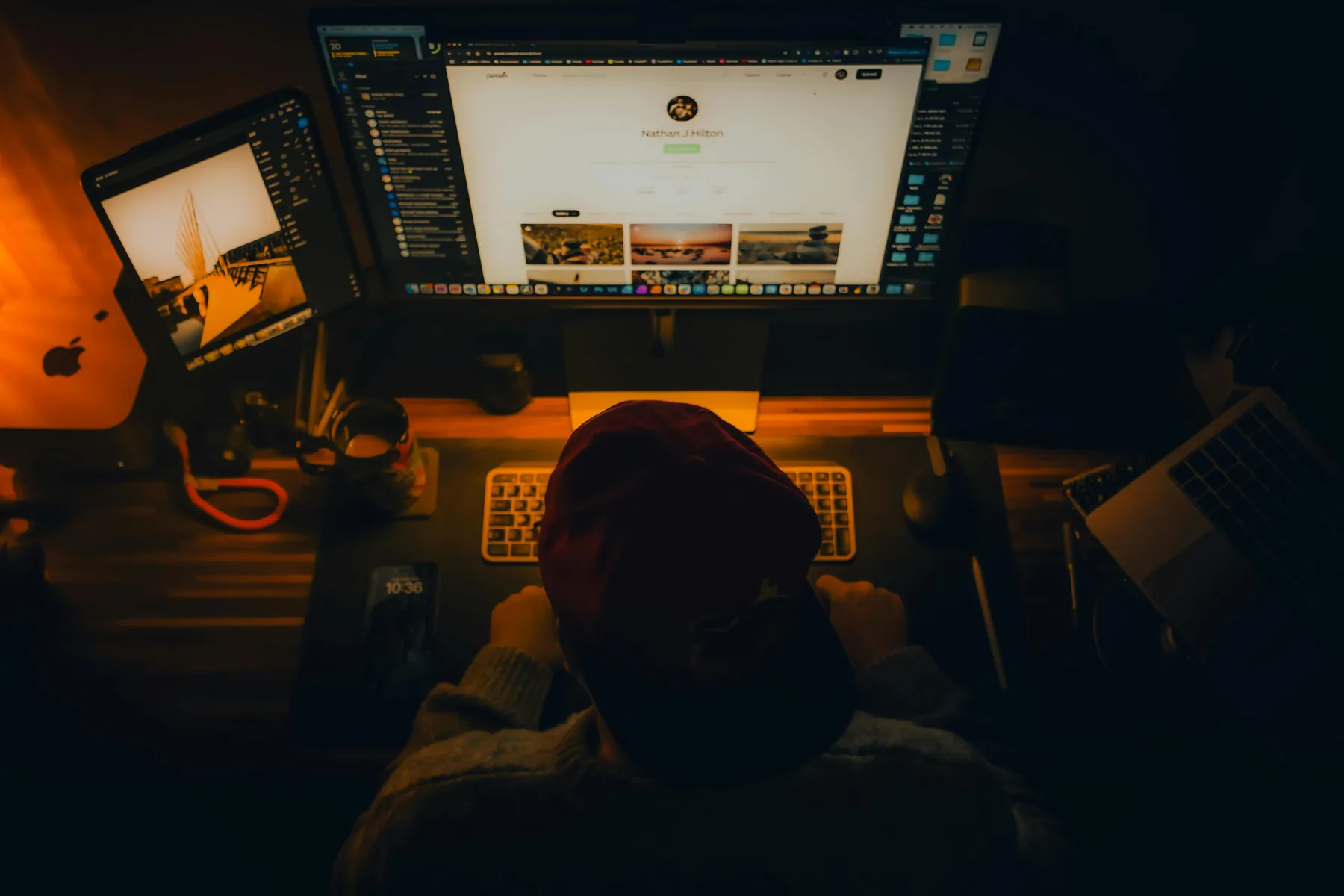 Overhead shot of a content creator editing setup with RGB keyboard